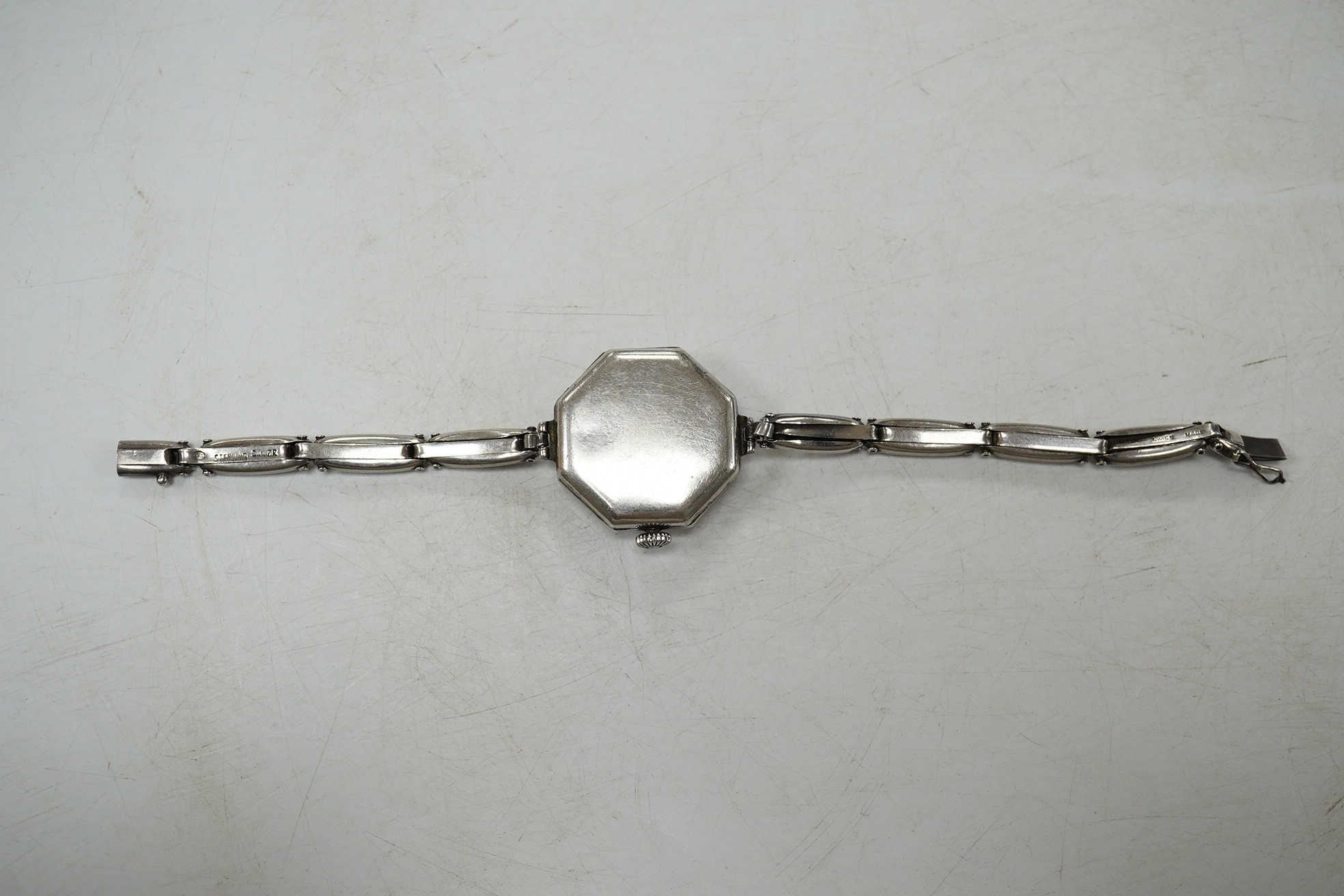 A lady's early 20th century continental sterling and enamel octagonal manual wind wrist watch, on a sterling expanding bracelet, 16.8cm. Condition - poor to fair